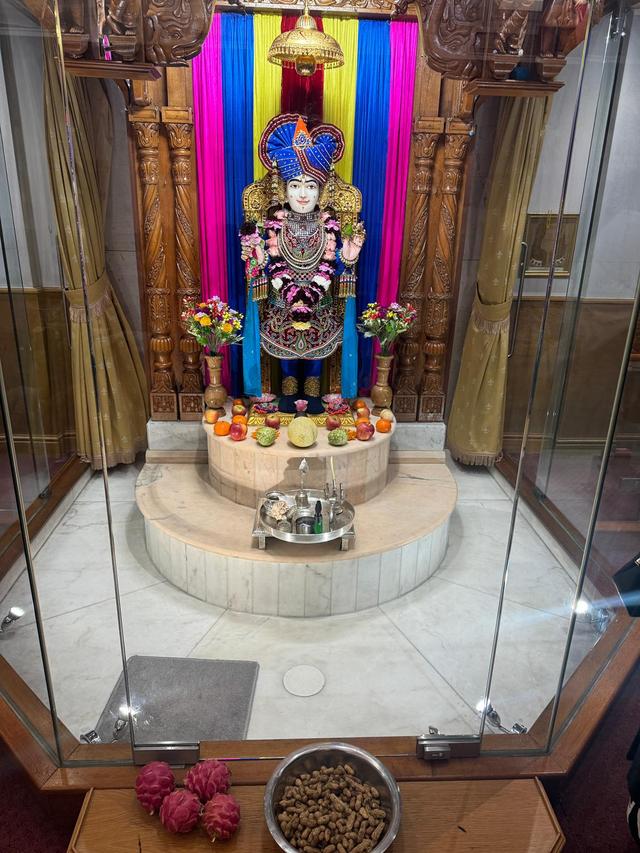 Why is there fruit in front of the murti pictured?